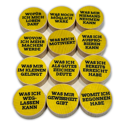 Holzsteine mit stärkenden Aufklebern für Coaching, Supervision und Ressourcenarbeit